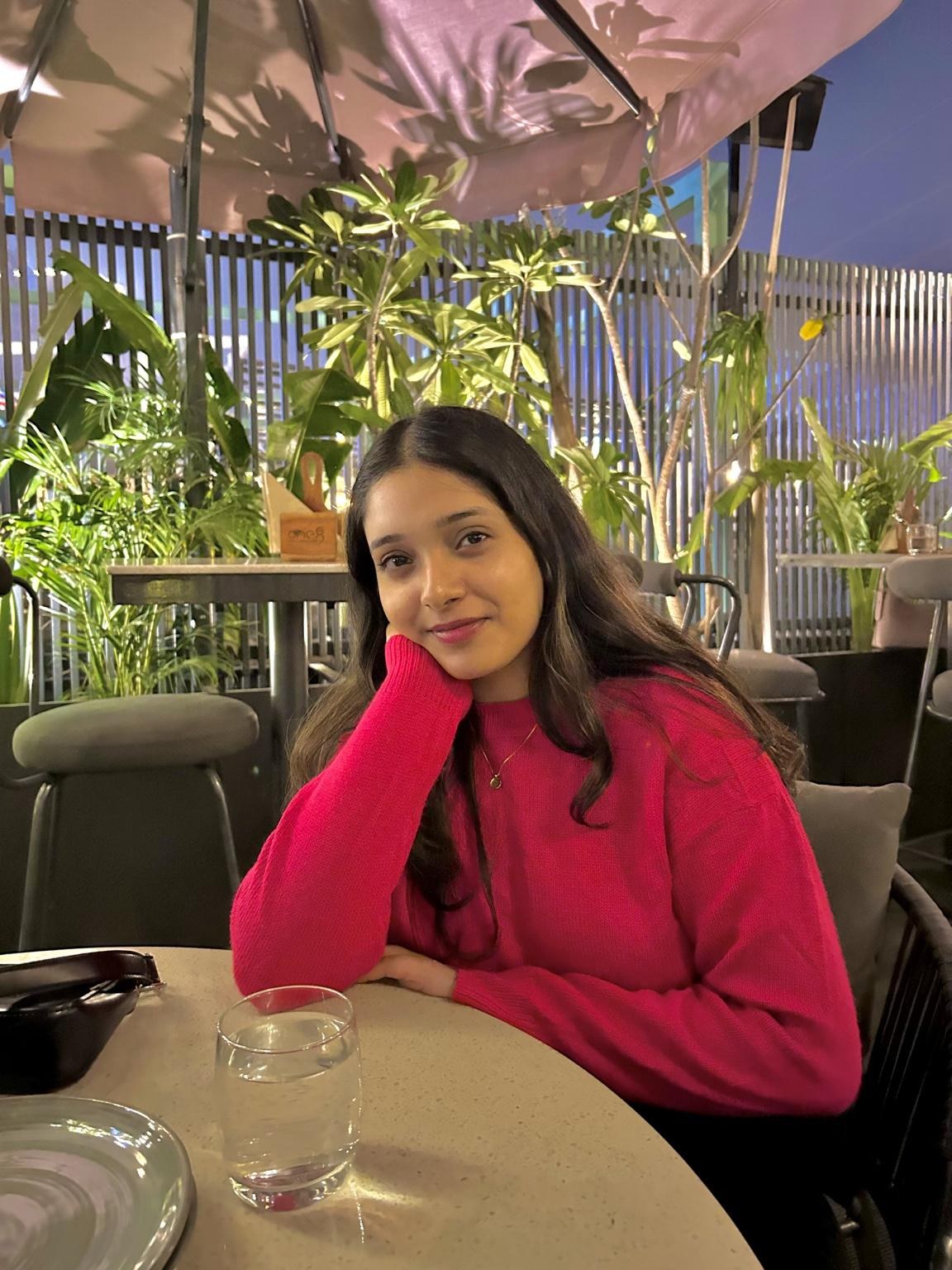 Harshita Arya in a pink sweater
